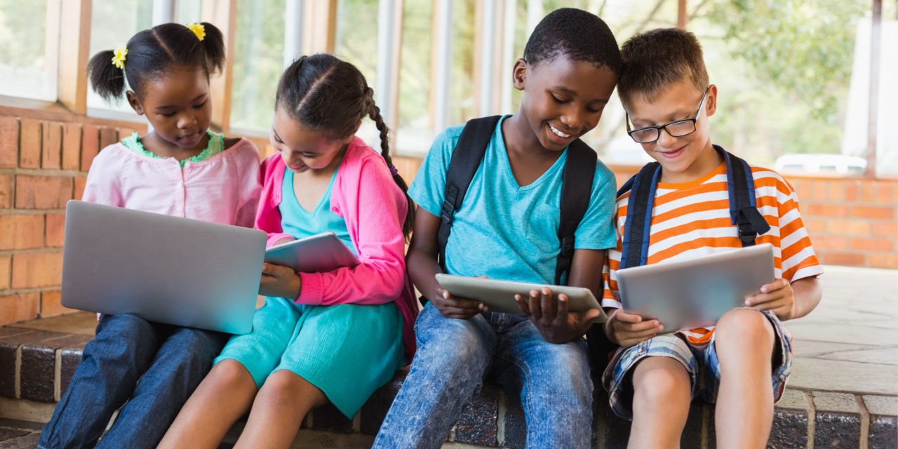 Elementary Students Bring District Issued Devices For First Day of In-Person Learning