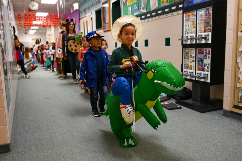 Student with dinosaur costume