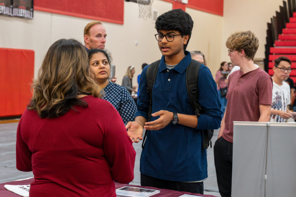 college fair participant talking to college rep
