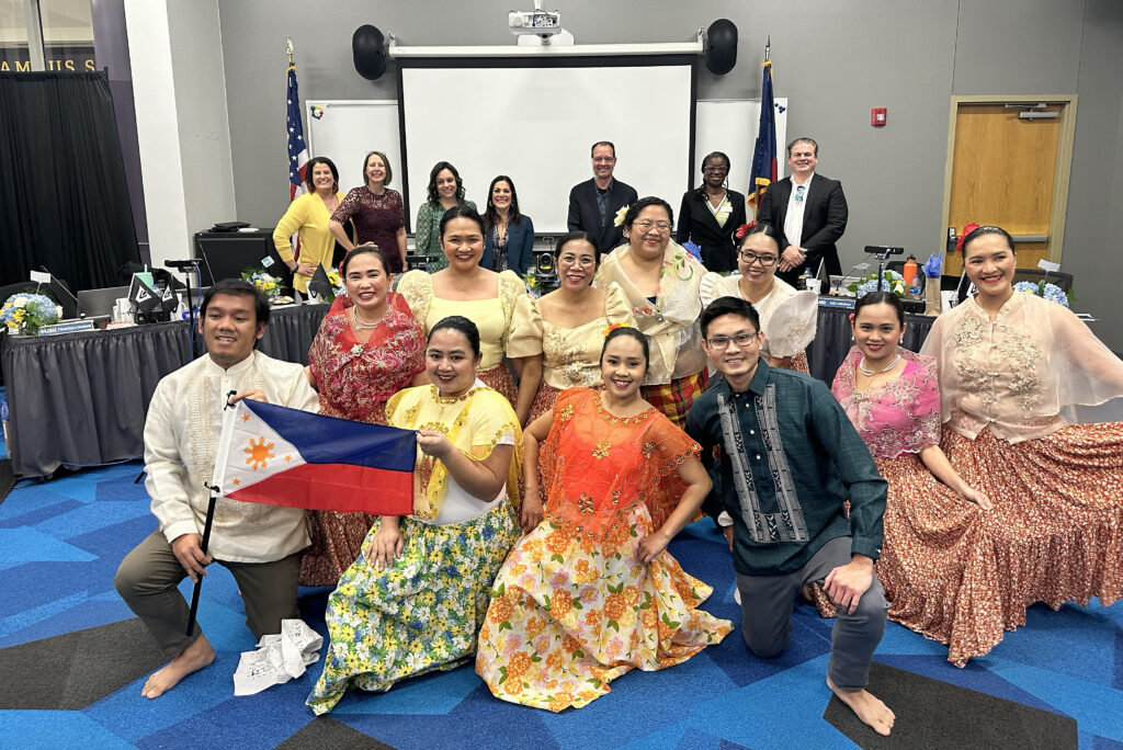 Filipino Teachers pose with the Board