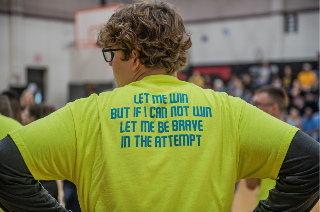 Leander Lazer wearing team t-shirt displaying motto