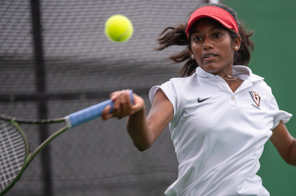 Student tennis player mid-game