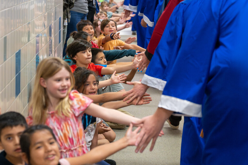 Elementary School Students with High School students during Senior walks before graduation