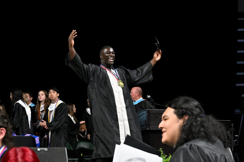Vandegrift student addresses fellow students on stage during graduation