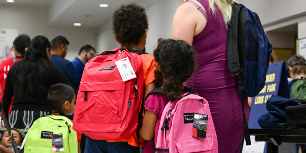 Students with new backpacks at the Backpack attack event, July 2024