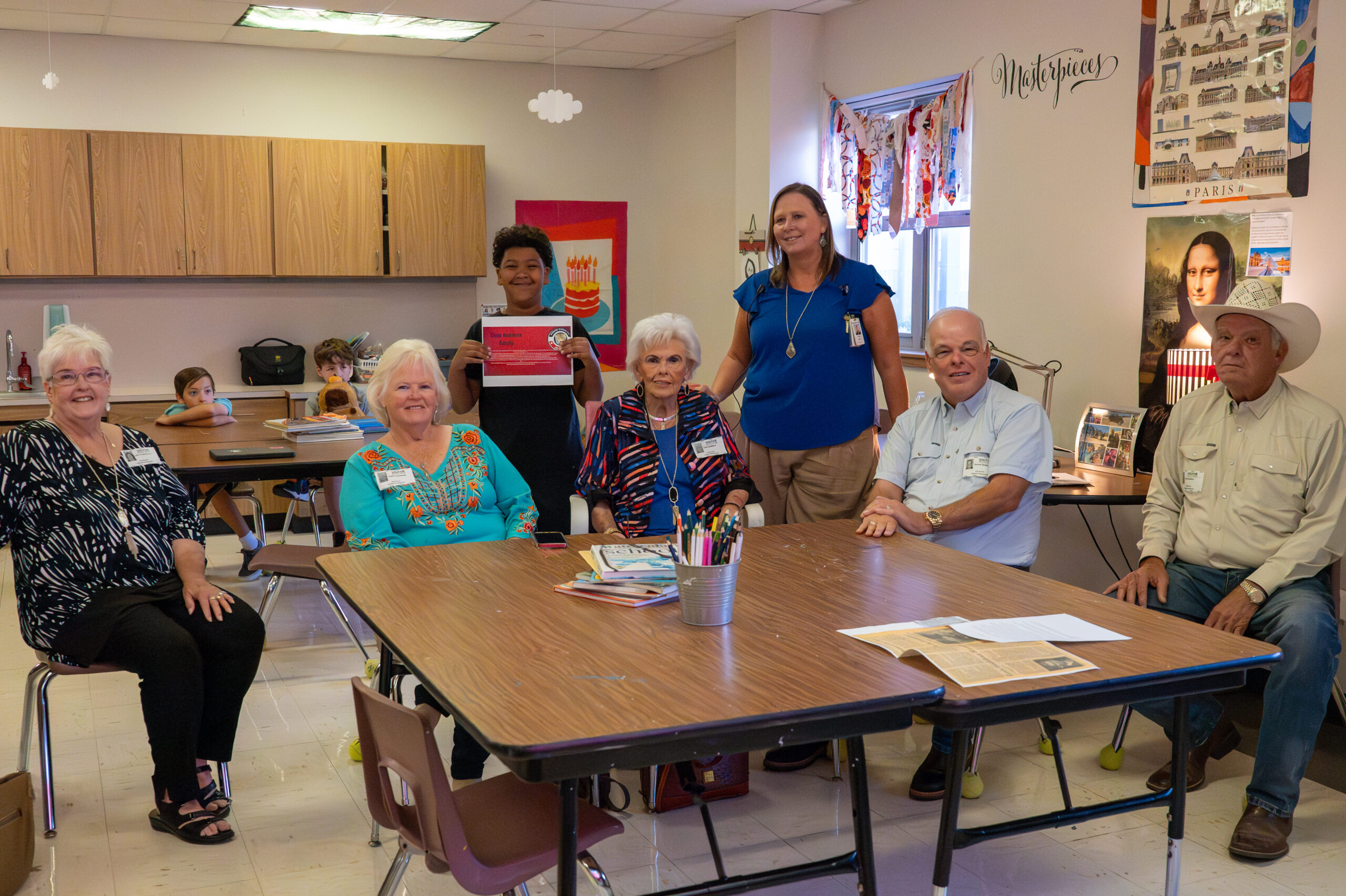Giddens Elementary School principal poses with the Giddens family and a 5th-grade student