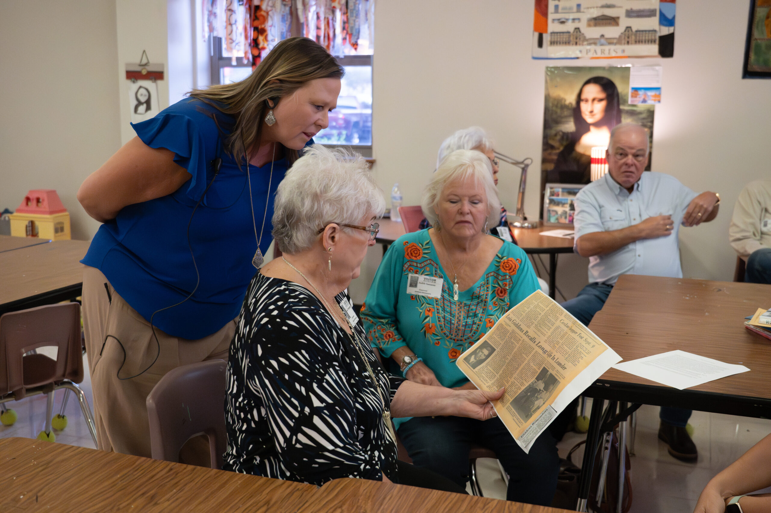 The Giddens family shows a newspaper clipping to the Giddens Elementary principal