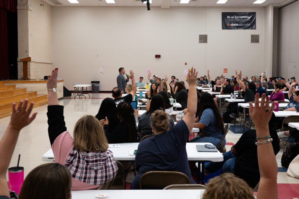 Participants raise their hands during a CIC session