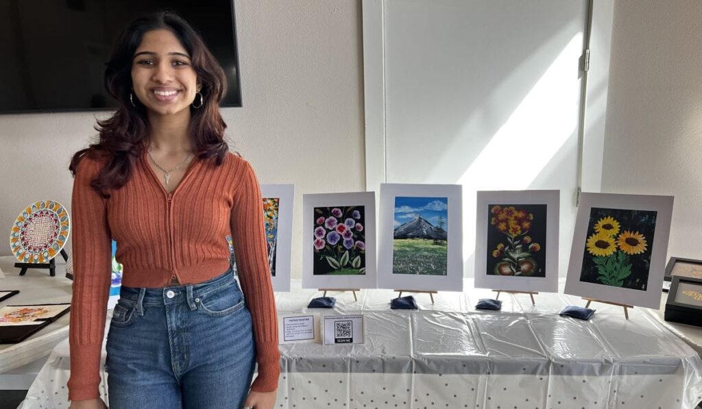 Vandegrift HS junior Shreya Poladia poses with several art pieces for an art show she hosts with her non-profit organization.